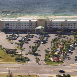 View of Hampton Inn Pensacola Beach with view of parking and beach
