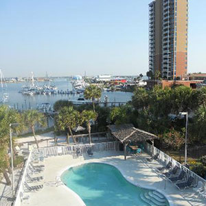 Travelodge Pensacola Beach with view of pool and docks