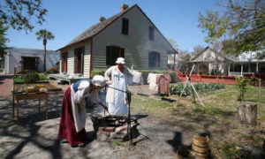 2 people dressed in 1800s clothing in a historic scene