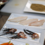 Chef Irv Miller preps lionfish dish, filets on plate