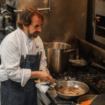 Chef Irv Miller preps lionfish dish, pan frying filets