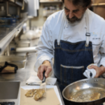 Chef Irv Miller preps lionfish dish, removing pan fried filets